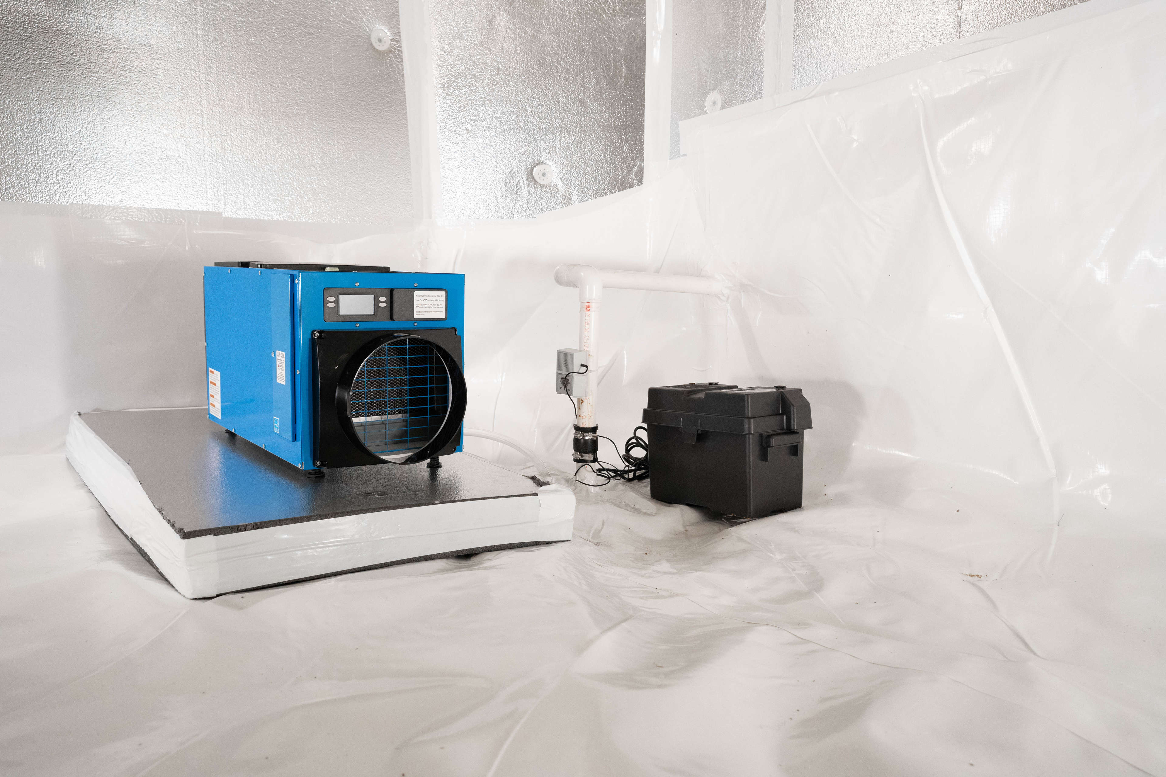 dehumidifier and sump pump with a battery backup installed in an encapsulated crawl space