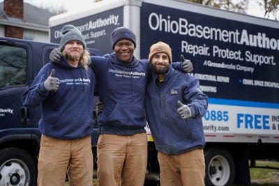 Ohio Basement Authority crew members standing by a company truck