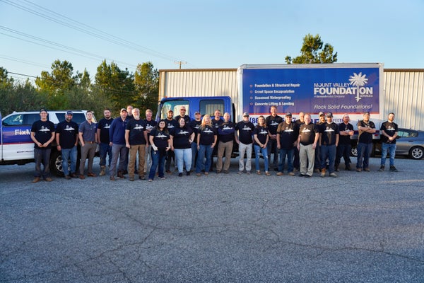 Mount Valley Foundation Repair team standing in front of work truck and warehouse