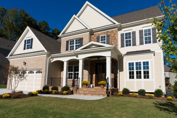 two story house and landscaped yard