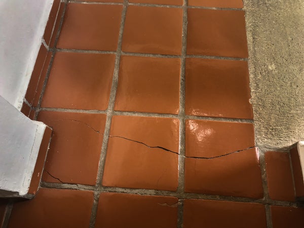 cracked tile floor in concrete slab foundation