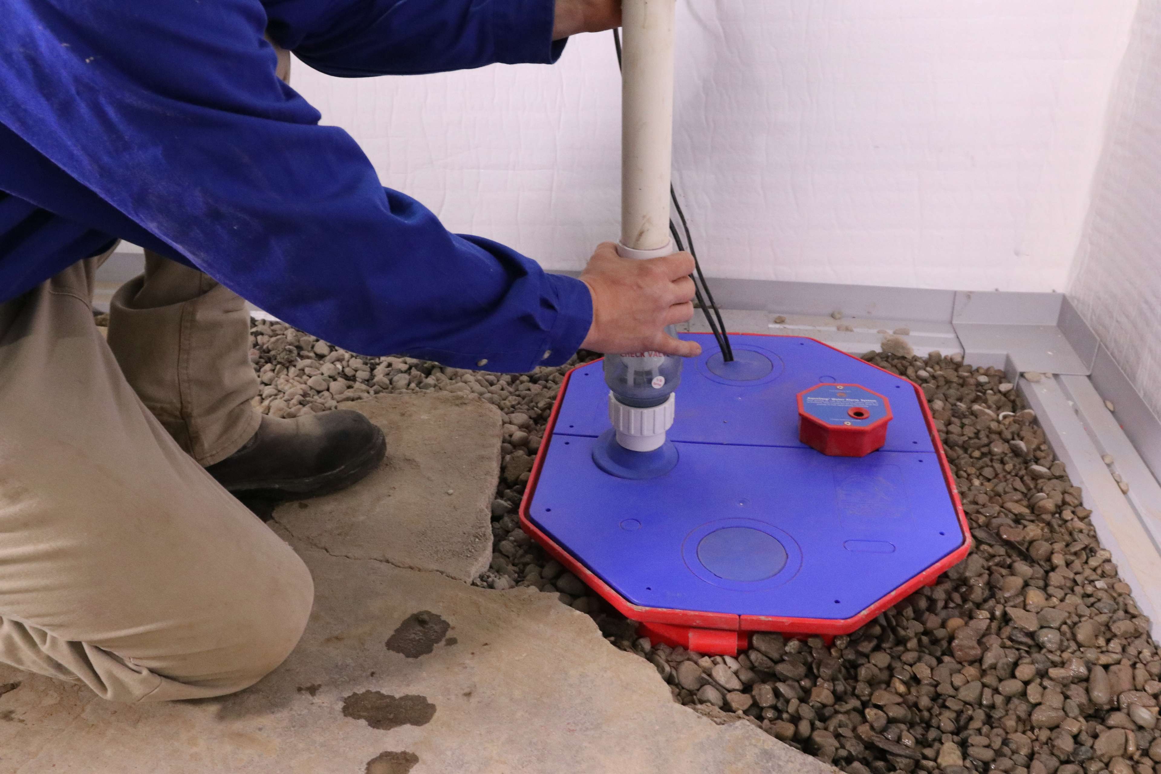 JES Foundation Repair crew installing basement sump pump system