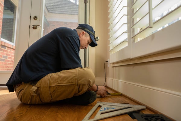 crew measuring interior floor gap