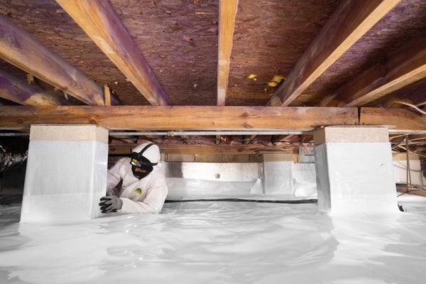 crew installing crawl space vapor barrier