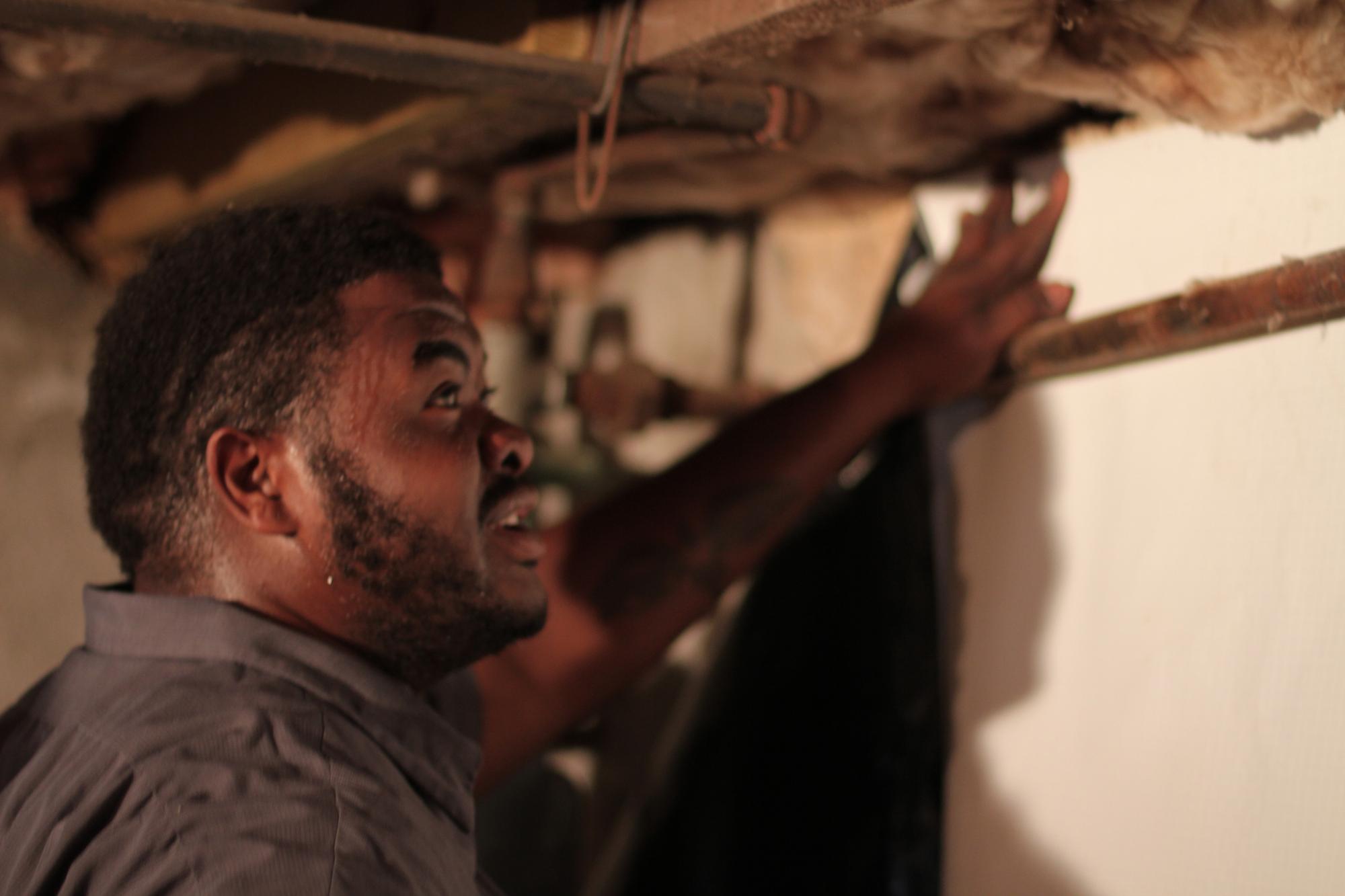 inspector measuring a basement wall