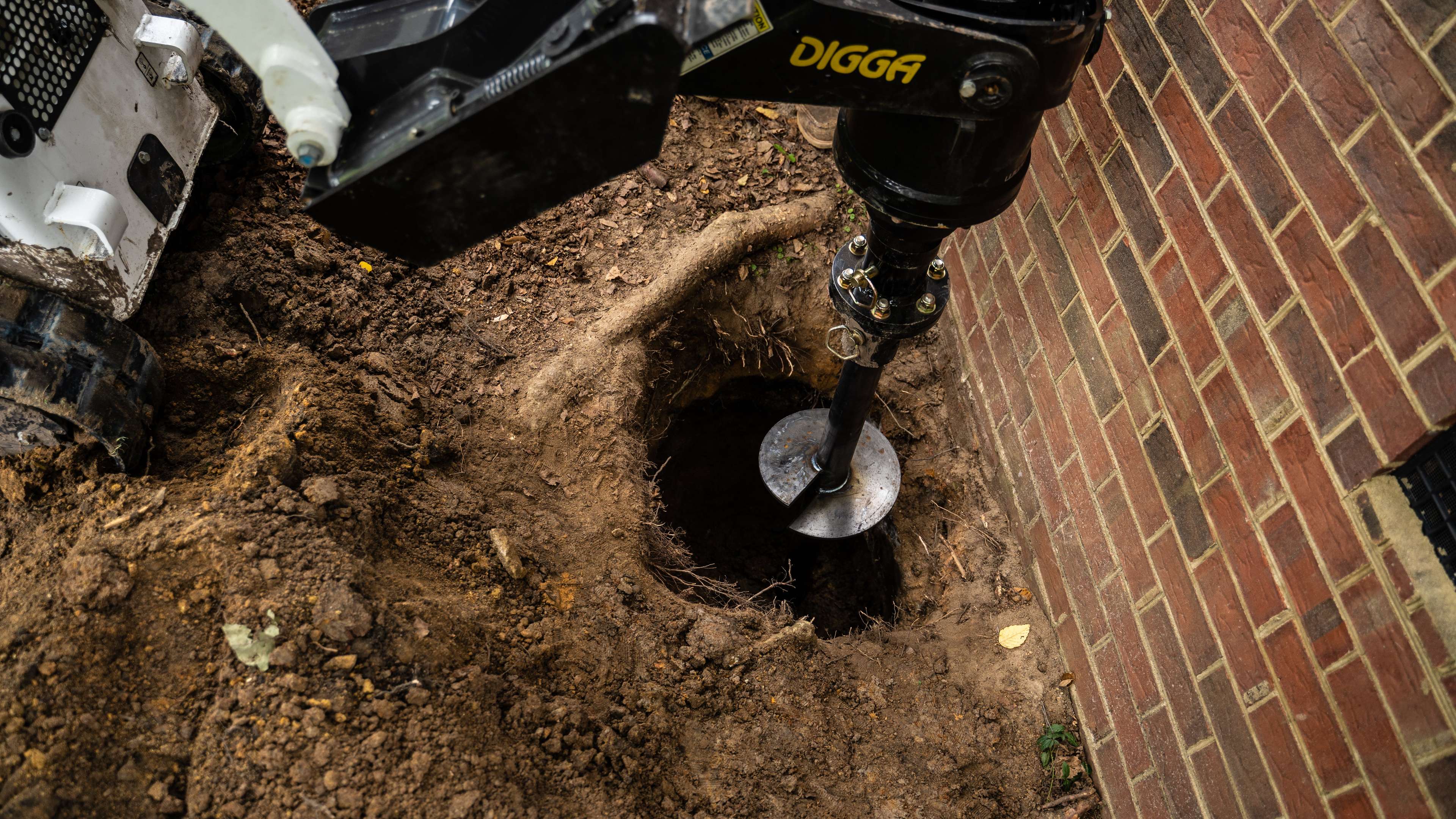 helical pier being driven into the ground