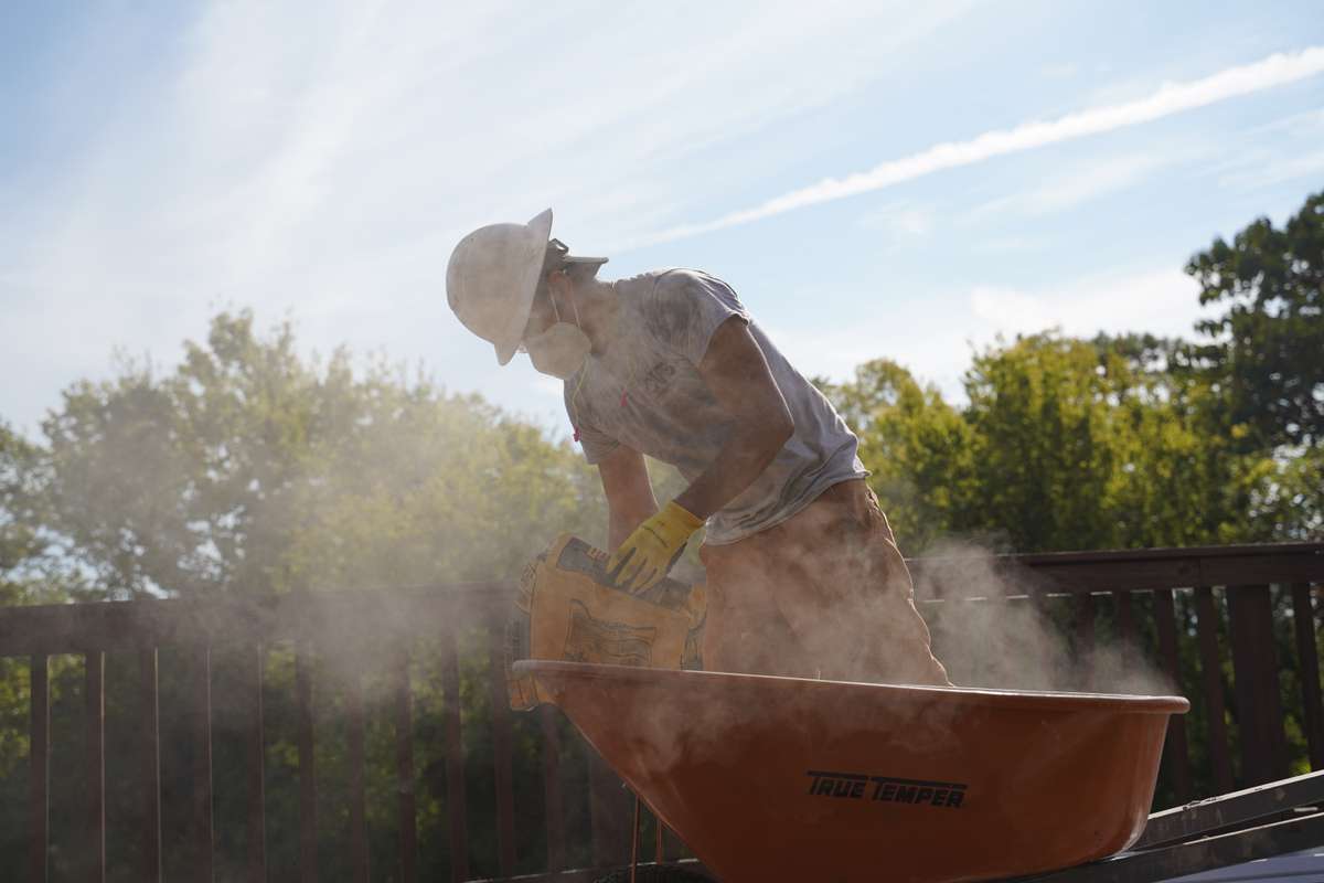 concrete bag dust worker wheel barrow