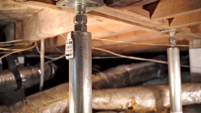 Crawl space jacks in a crawl space.