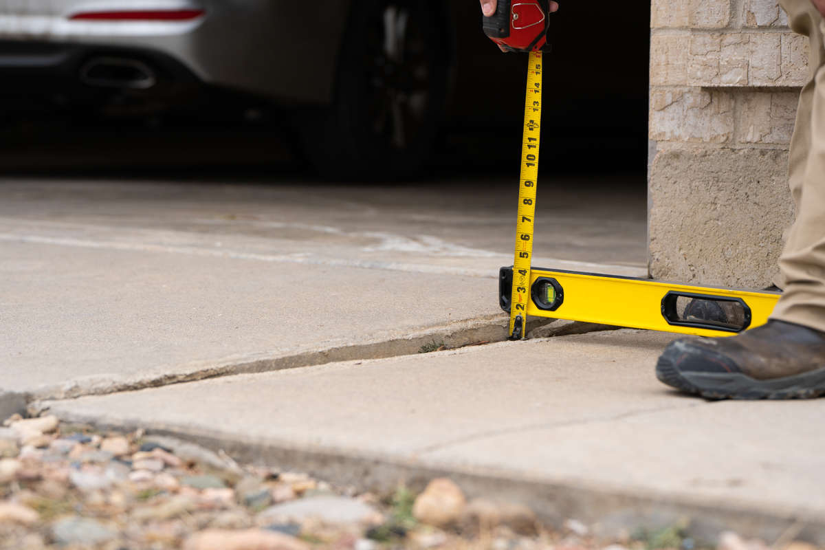 measuring uneven concrete that requires concrete lifting repair