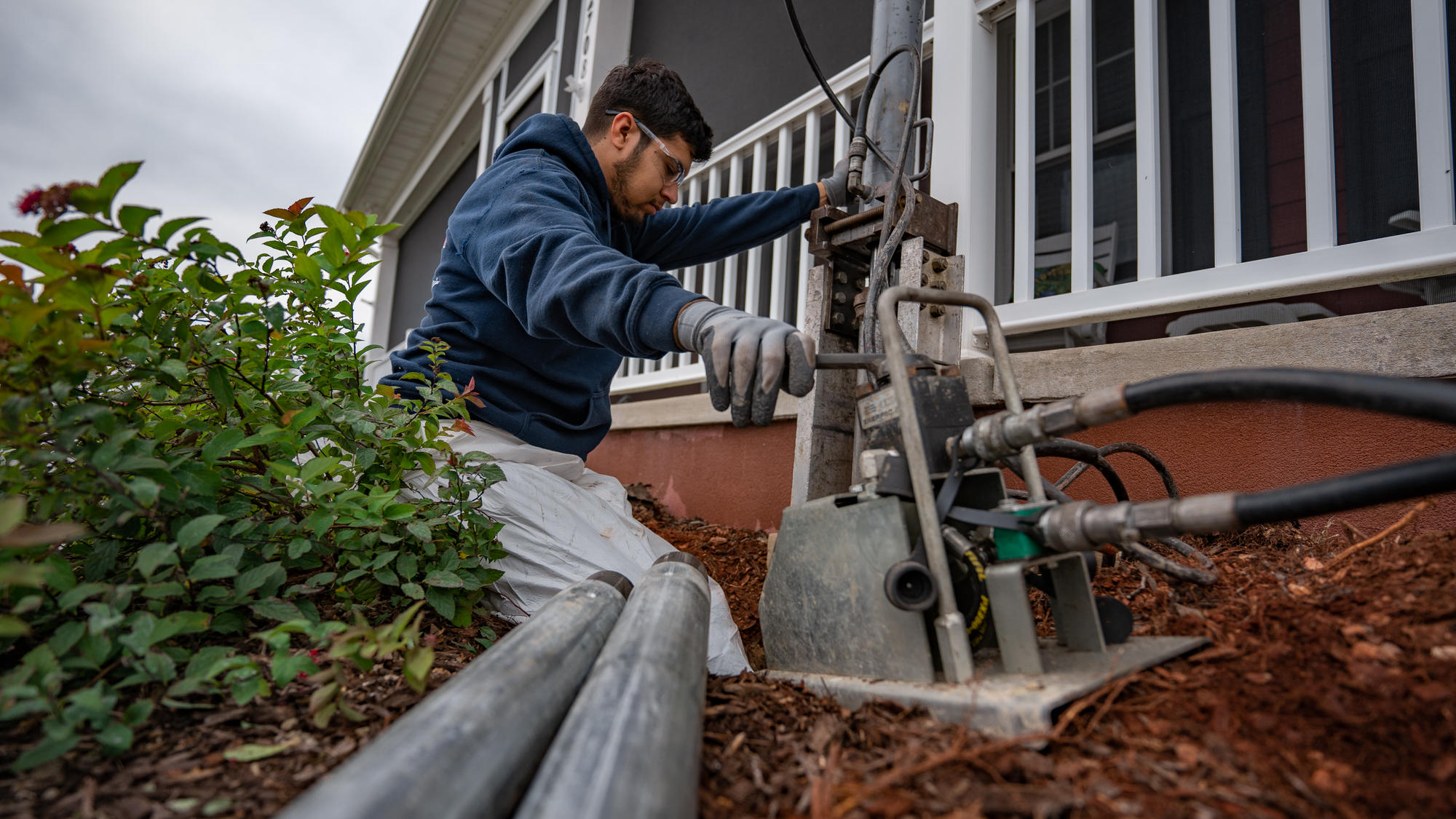 JES Foundation Repair crew installing a foundation pier  