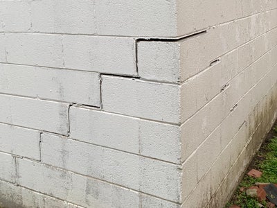 stair-step cracks on settling exterior foundation walls