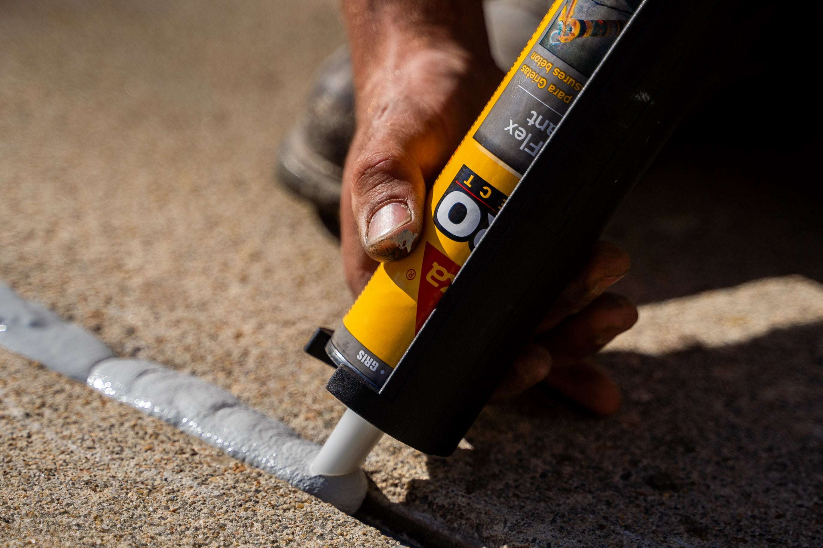 crew member seals concrete joints