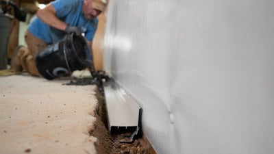 crew member installing interior drainage