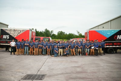 AFS Repair team standing in front two work trucks