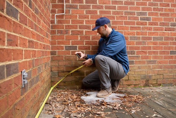 JES Foundation Repair inspector measuring house foundation