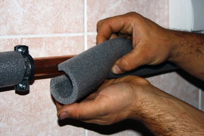 placing insulation on a plumbing pipe