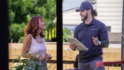 Groundworks man inspecting the outside of a home.