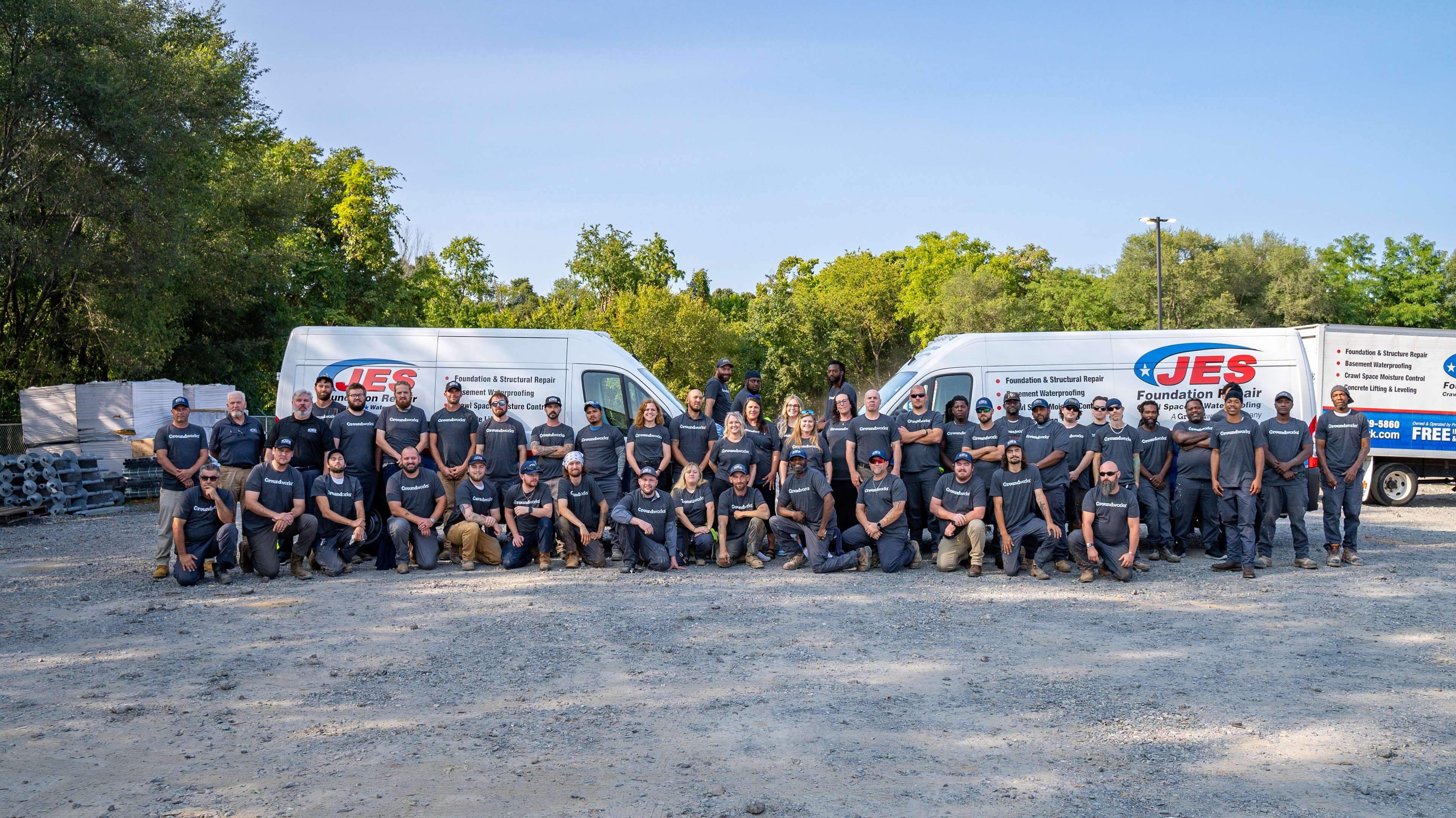 JES employees standing by company trucks