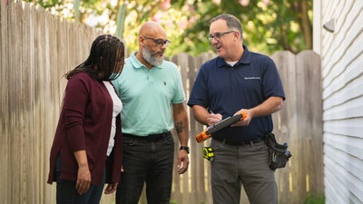 Groundworks inspector talking with homeowners.