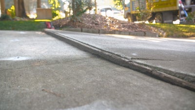 unlevel concrete driveway before poly injection