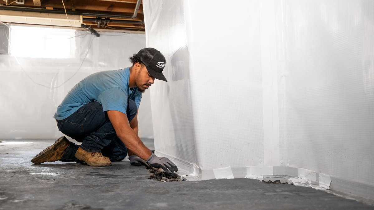 JES crew installing basement waterproofing