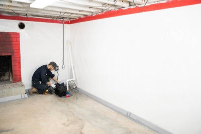 crew member installing basement sump pump