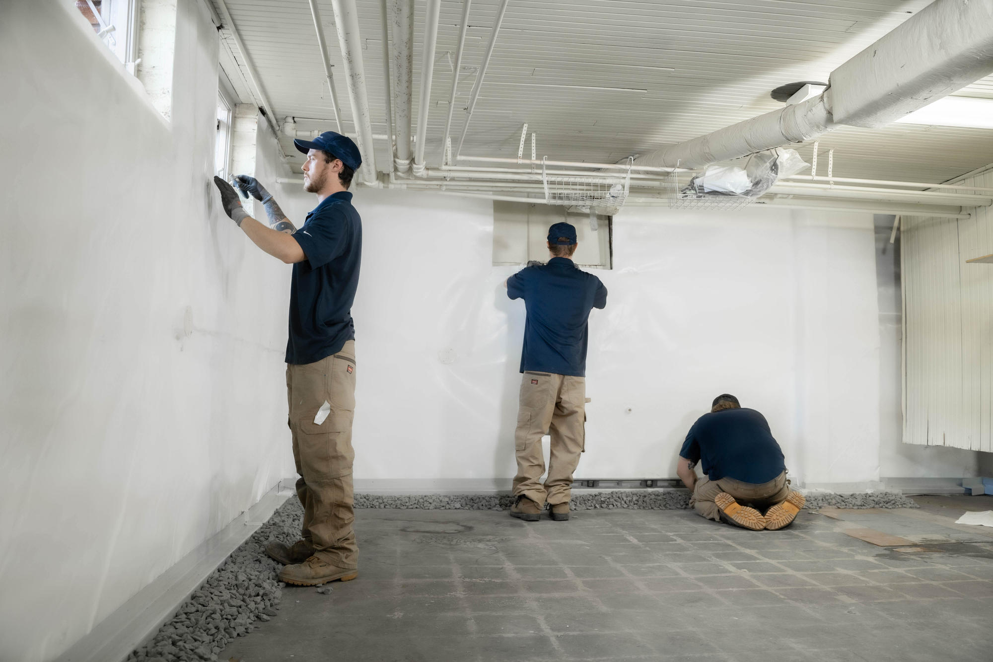 JES waterproofing technicians fixing basement window leaks