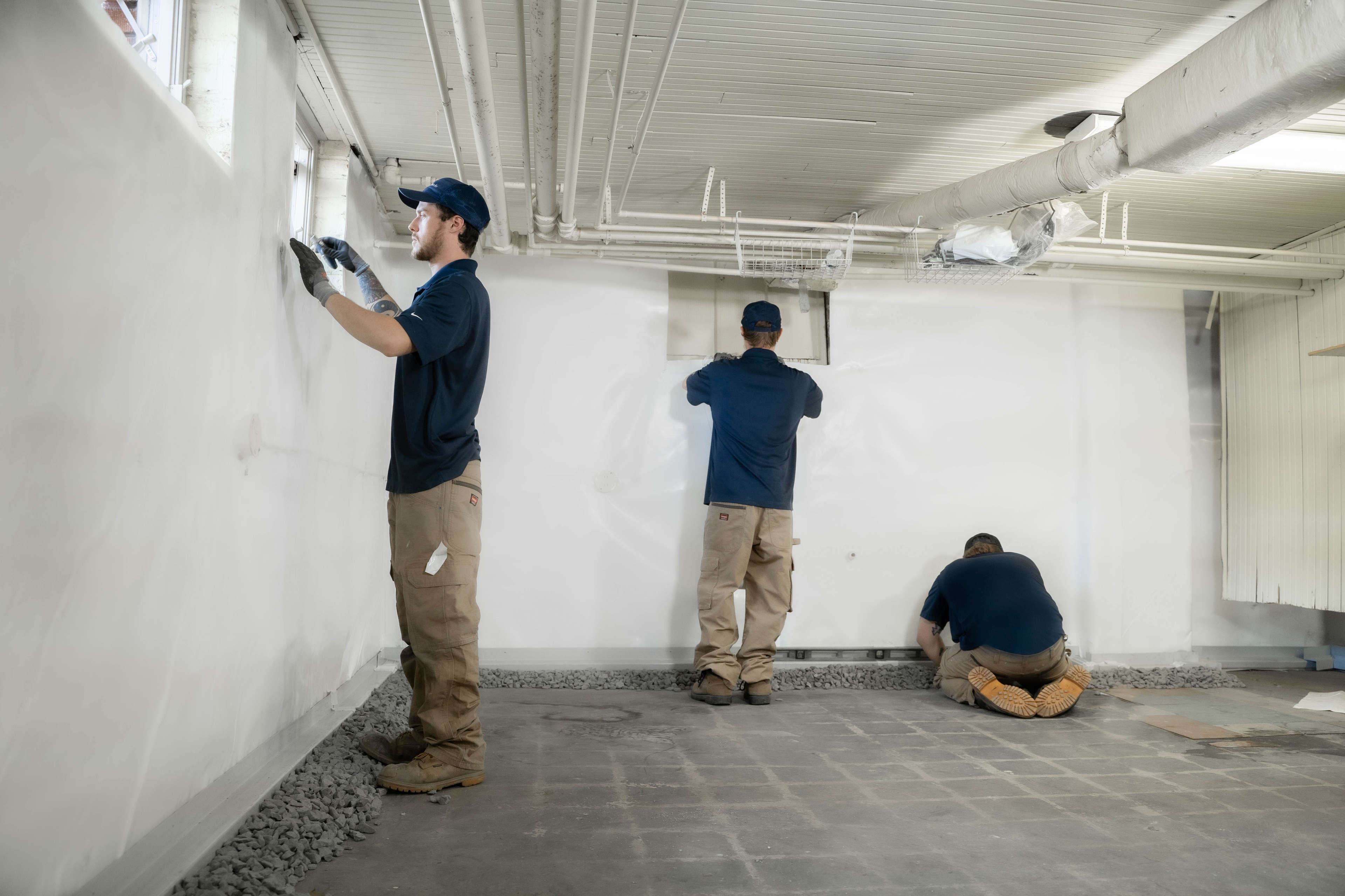 JES waterproofing technicians fixing basement window leaks