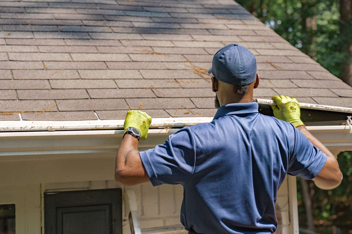 JES crew installing exterior gutter on house