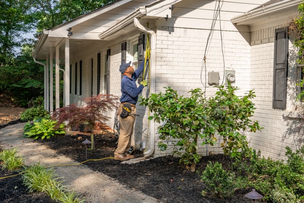 AFS inspector measuring exterior gutter