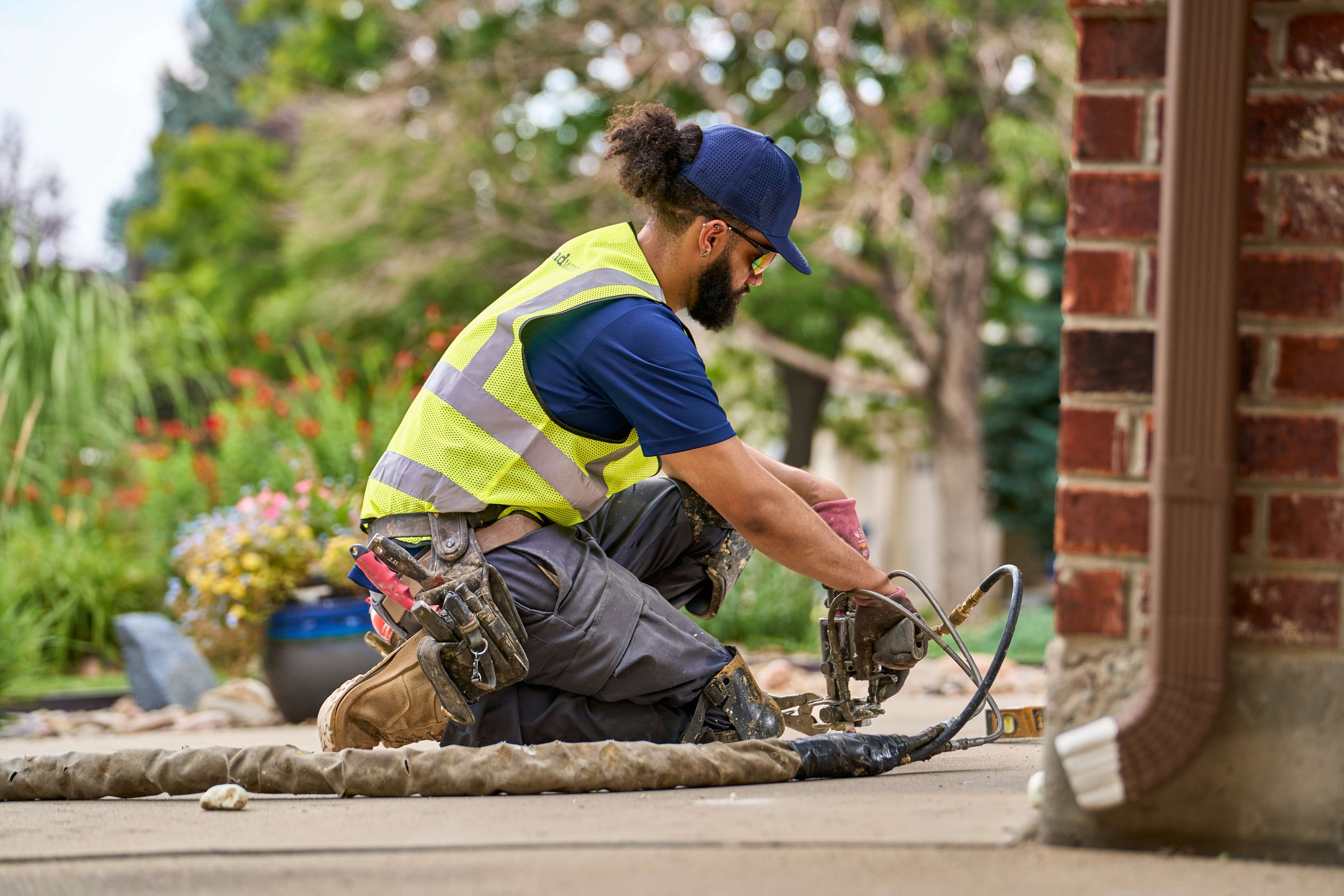crew member installs polyurethane foam under concrete