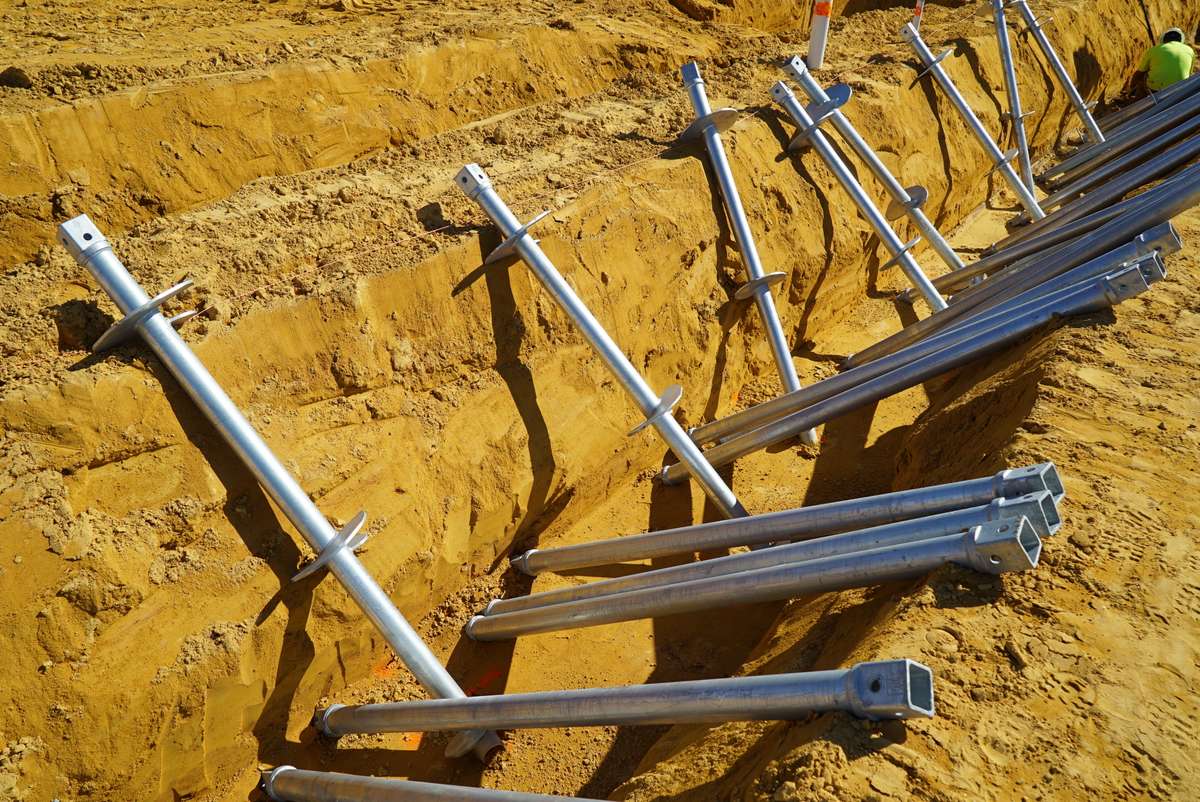 row of helical piers in dirt
