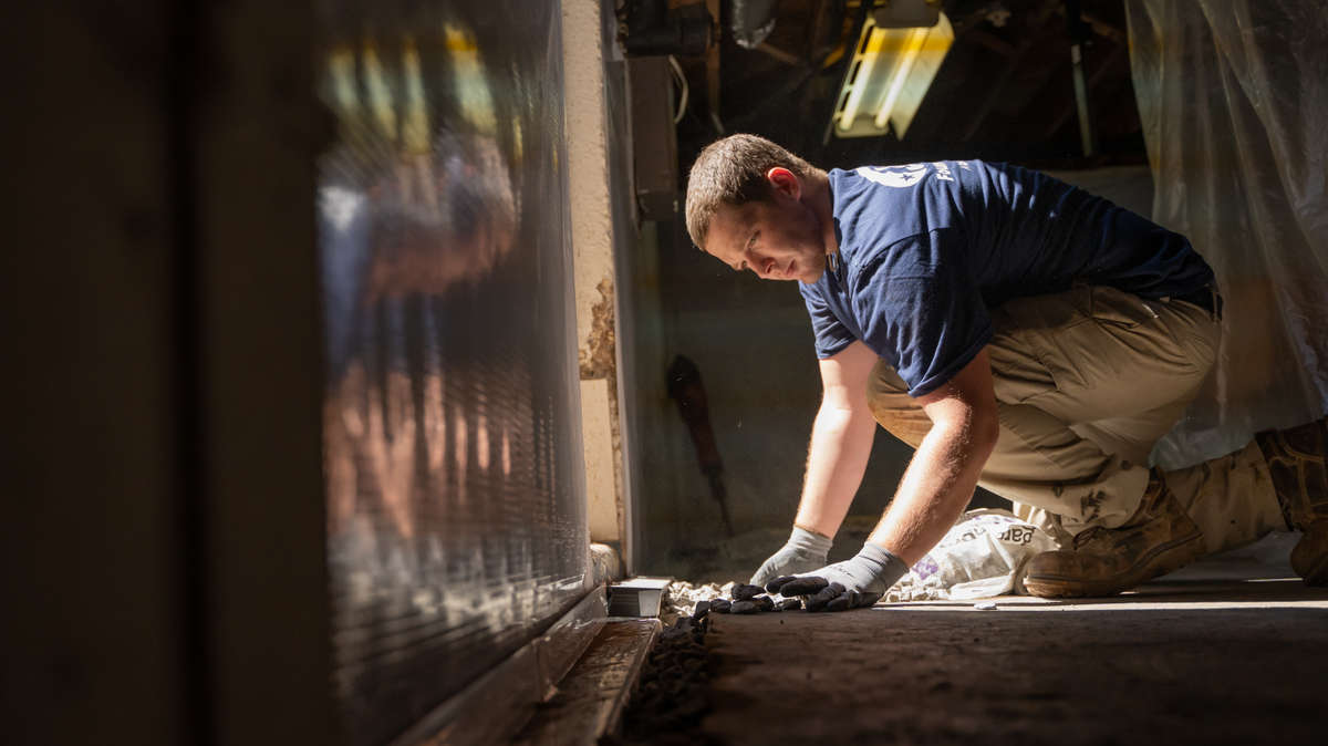 JES crew member installing basement waterproofing