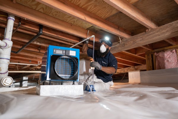 expert installing crawl space dehumidifier