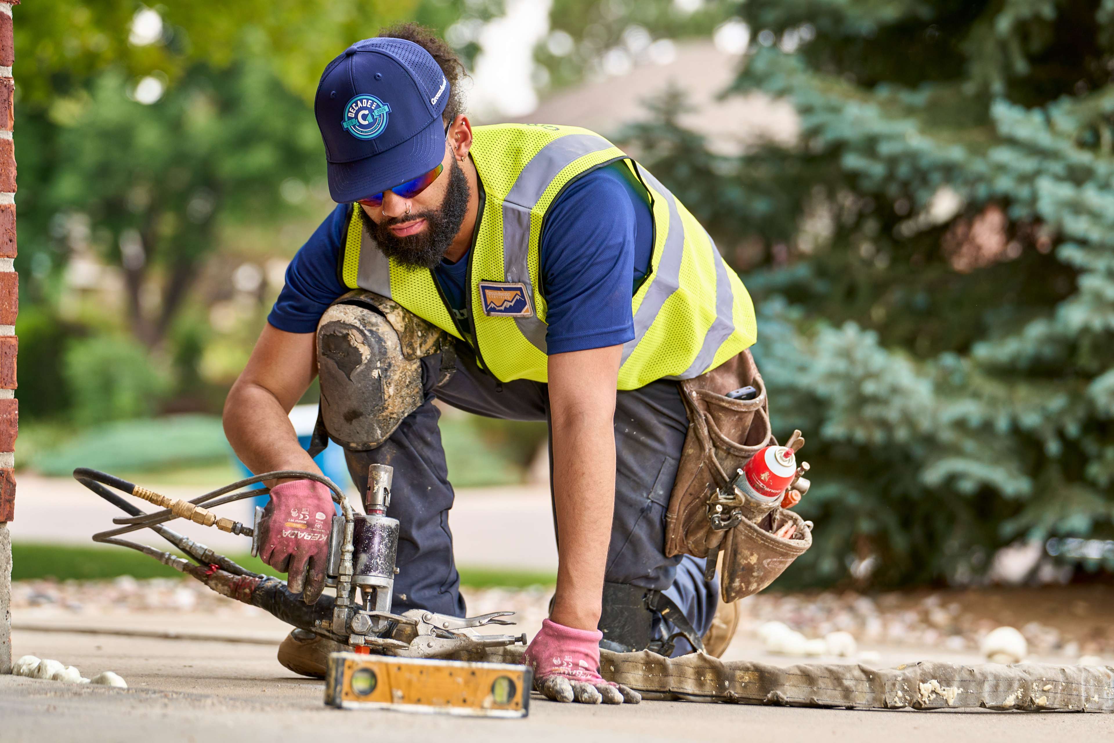 crew member injects polyurethane foam under concrete
