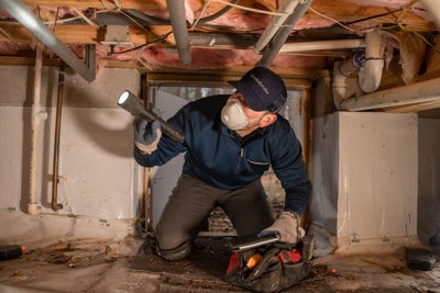 Groundworks inspector in a crawl space