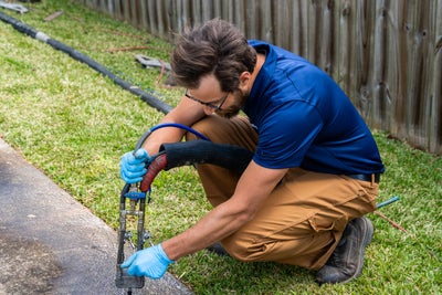 Groundworks worker injecting polyurethane