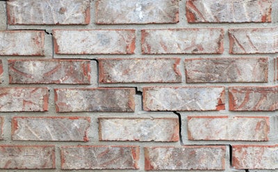 Cracked brick wall.