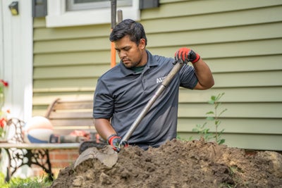 A1 technician digging for a sewer line replacement