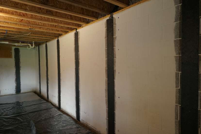 Carbon fiber reinforcement straps attached to a basement wall.