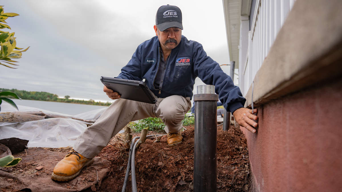 JES installer inspecting a foundation pier.