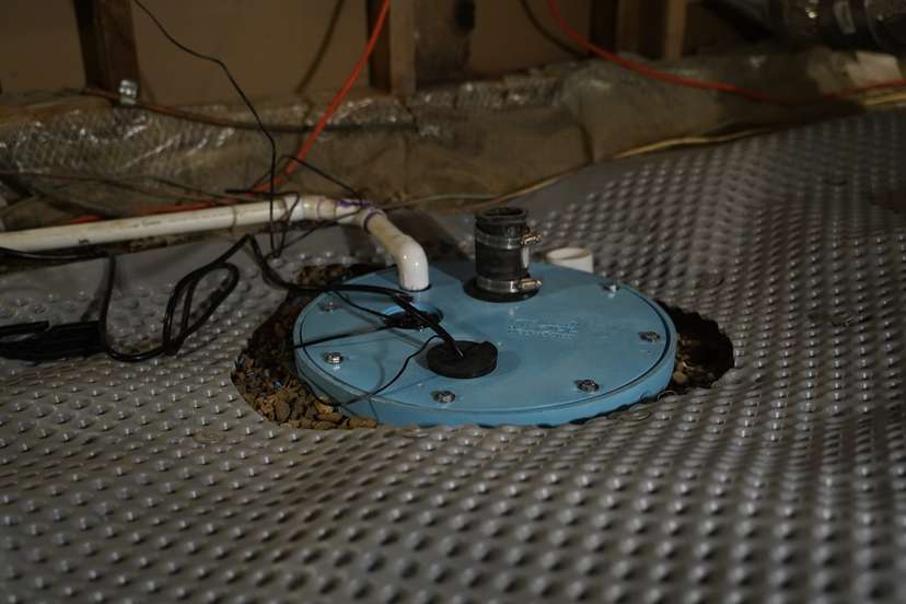 Crawl space sump pump being installed.