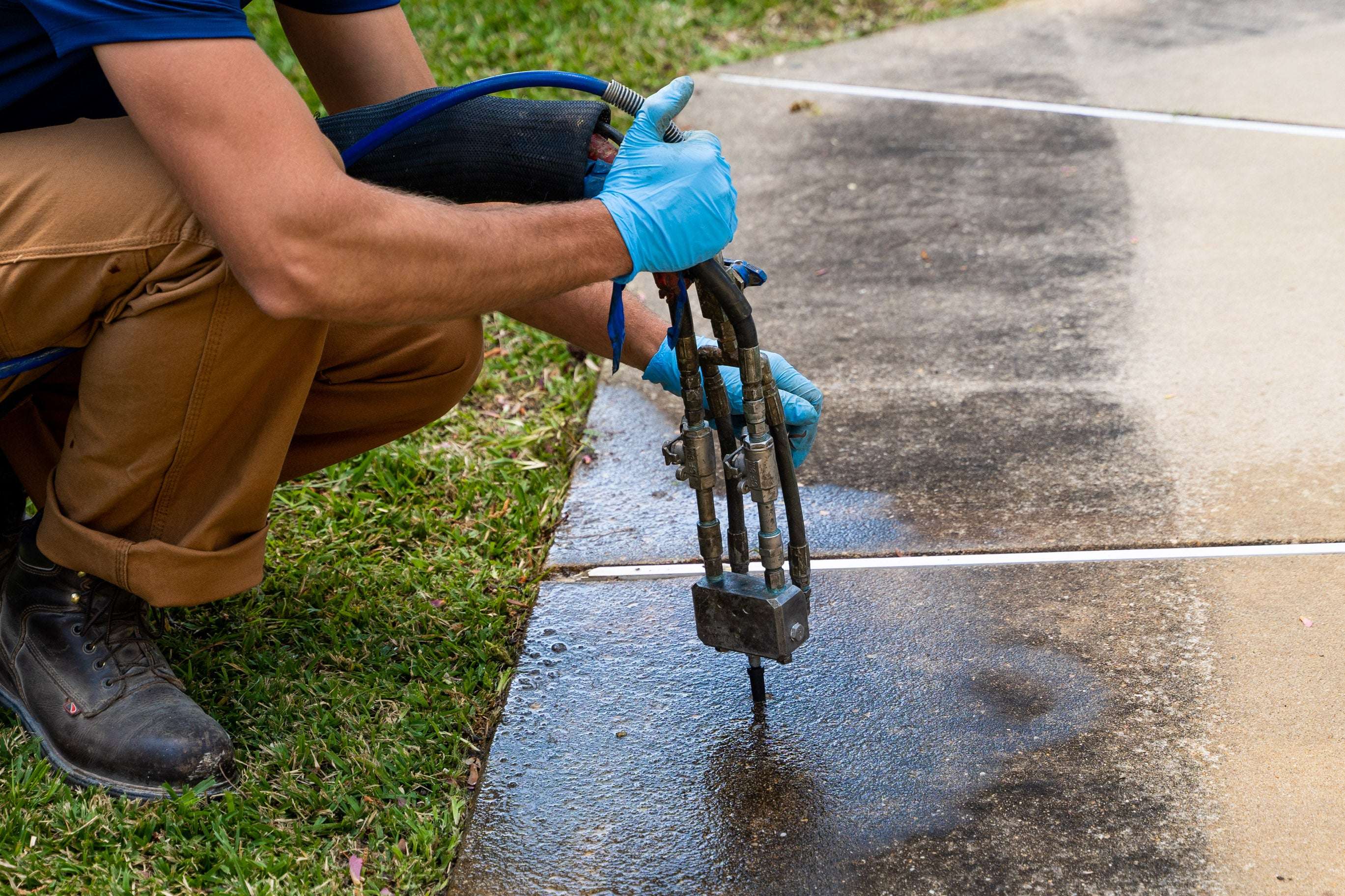 crew member installs polyurethane foam under concrete