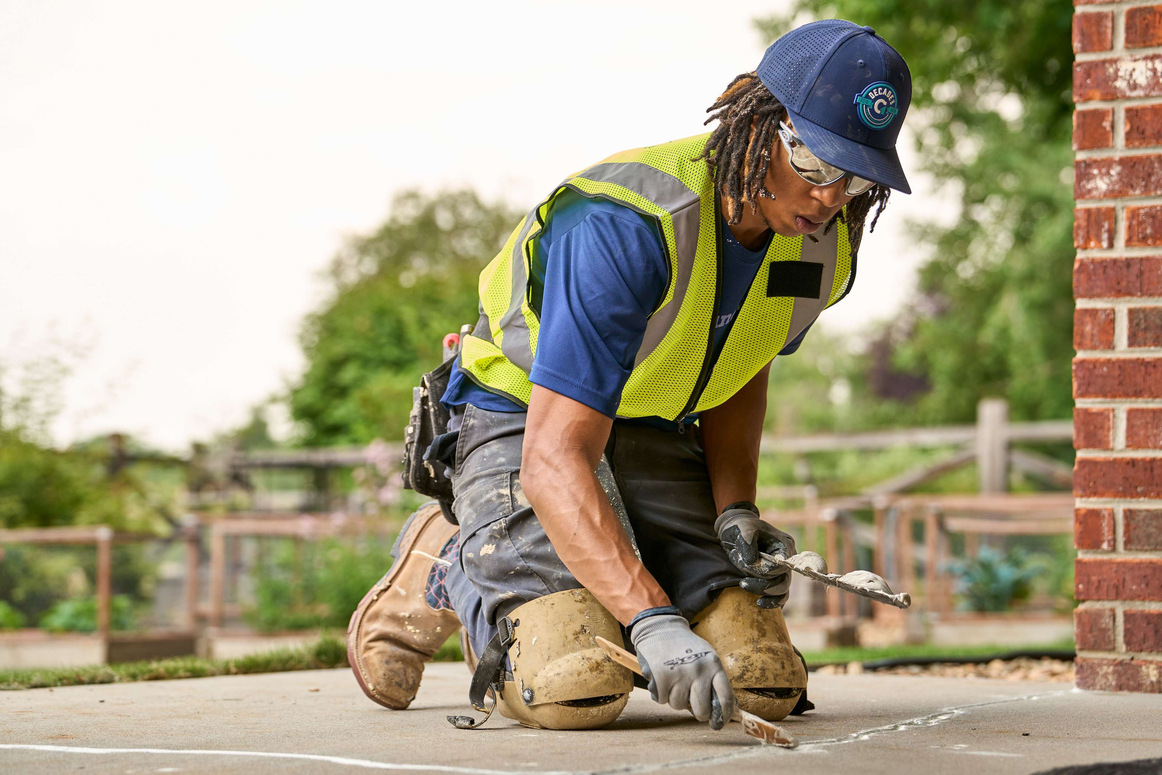 crew member applies crack sealant to concrete