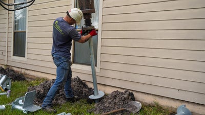 Crewman installing a foundation pier.