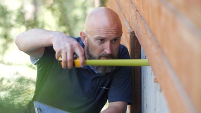 Groundworks inspector checking on a crawl space.