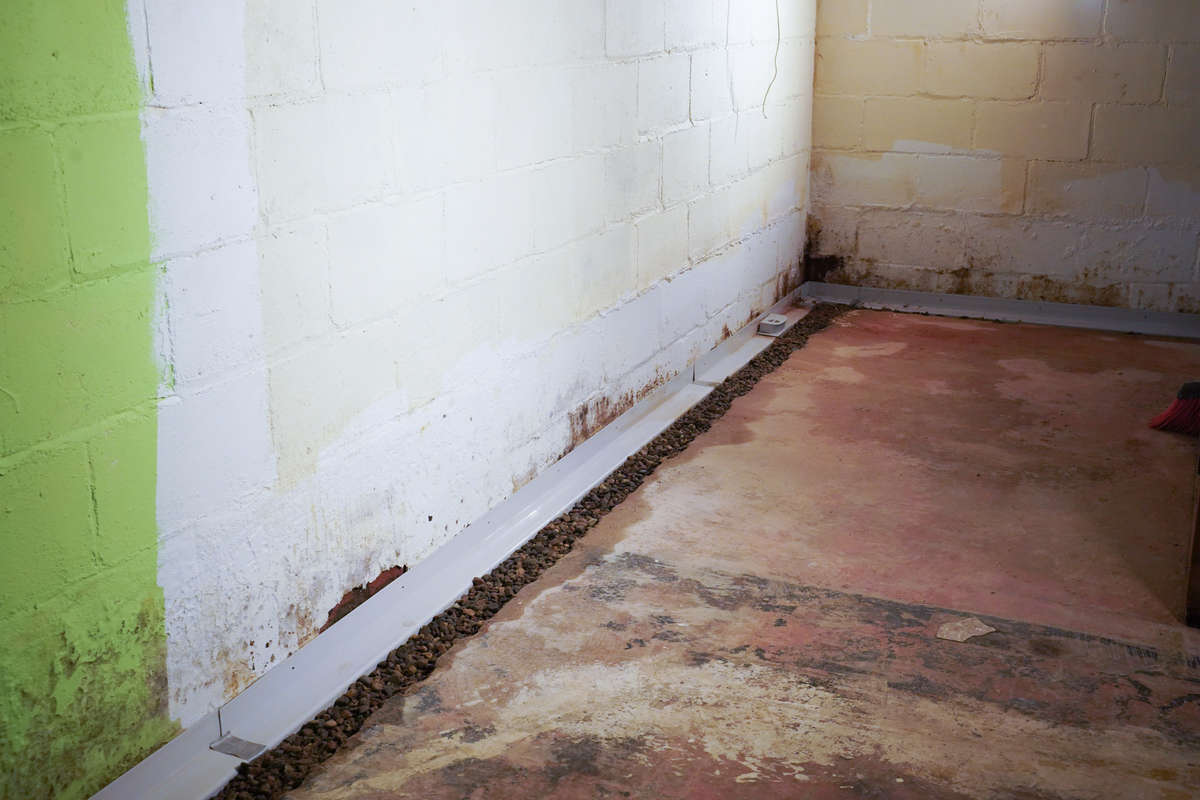 basement gutter system around perimeter of concrete basement floor