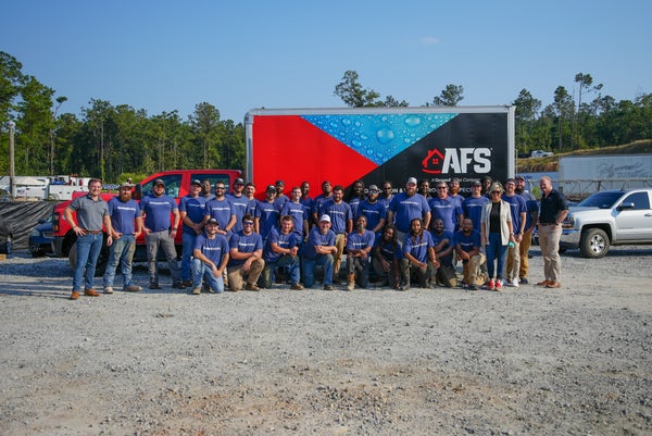 AFS Repair crew standing near branded work truck