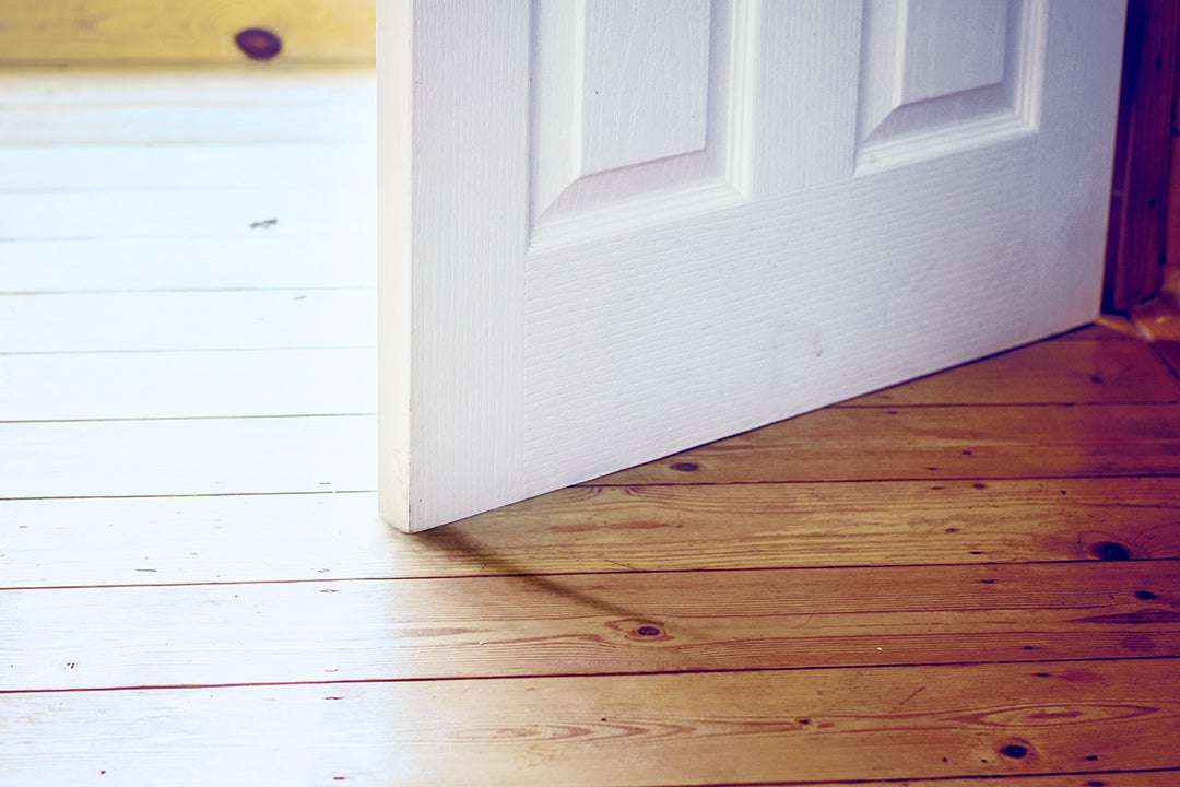 misaligned interior door scraping hardwood floor due to foundation settlement