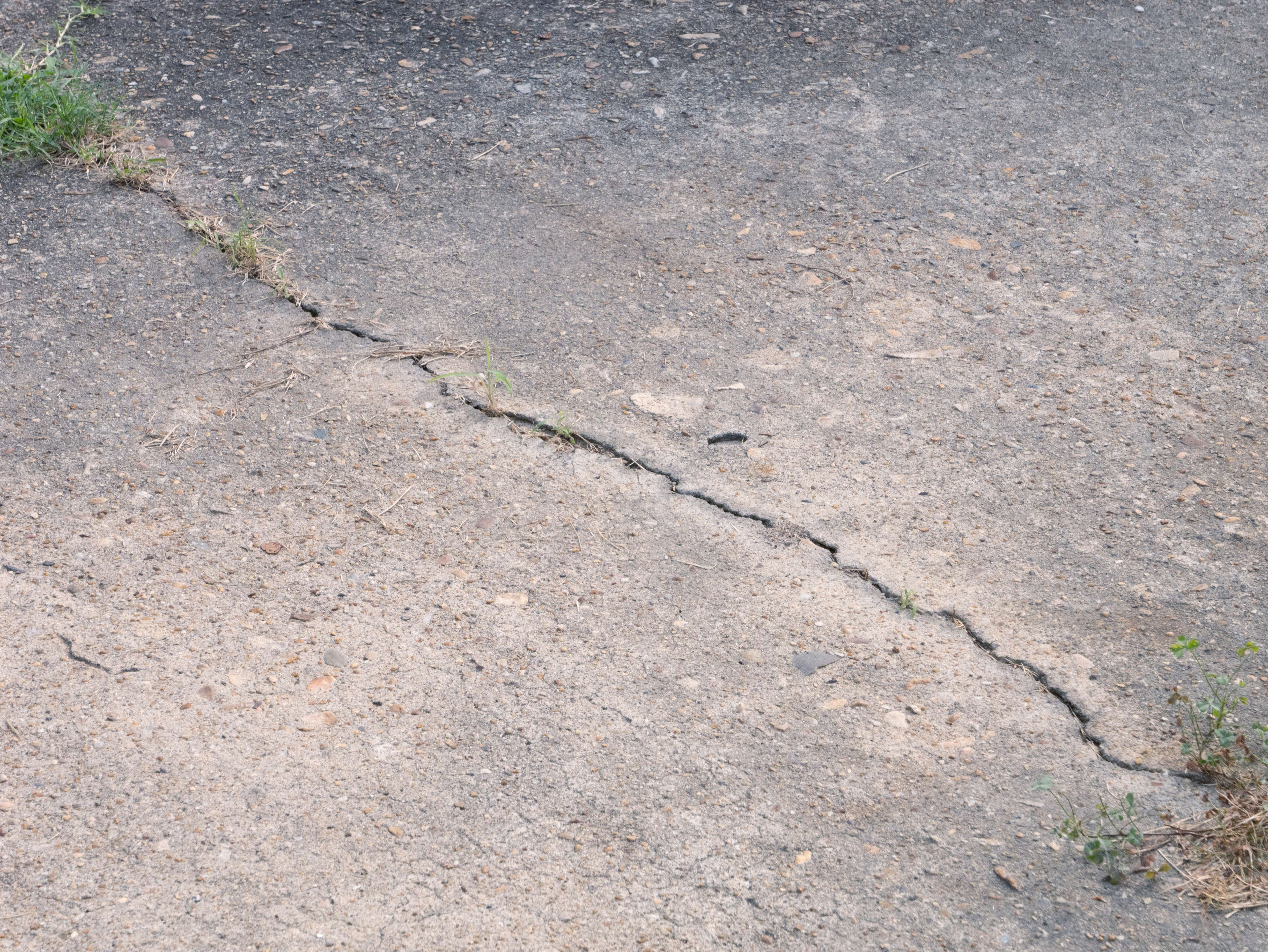 Cracked and sinking sidewalk
